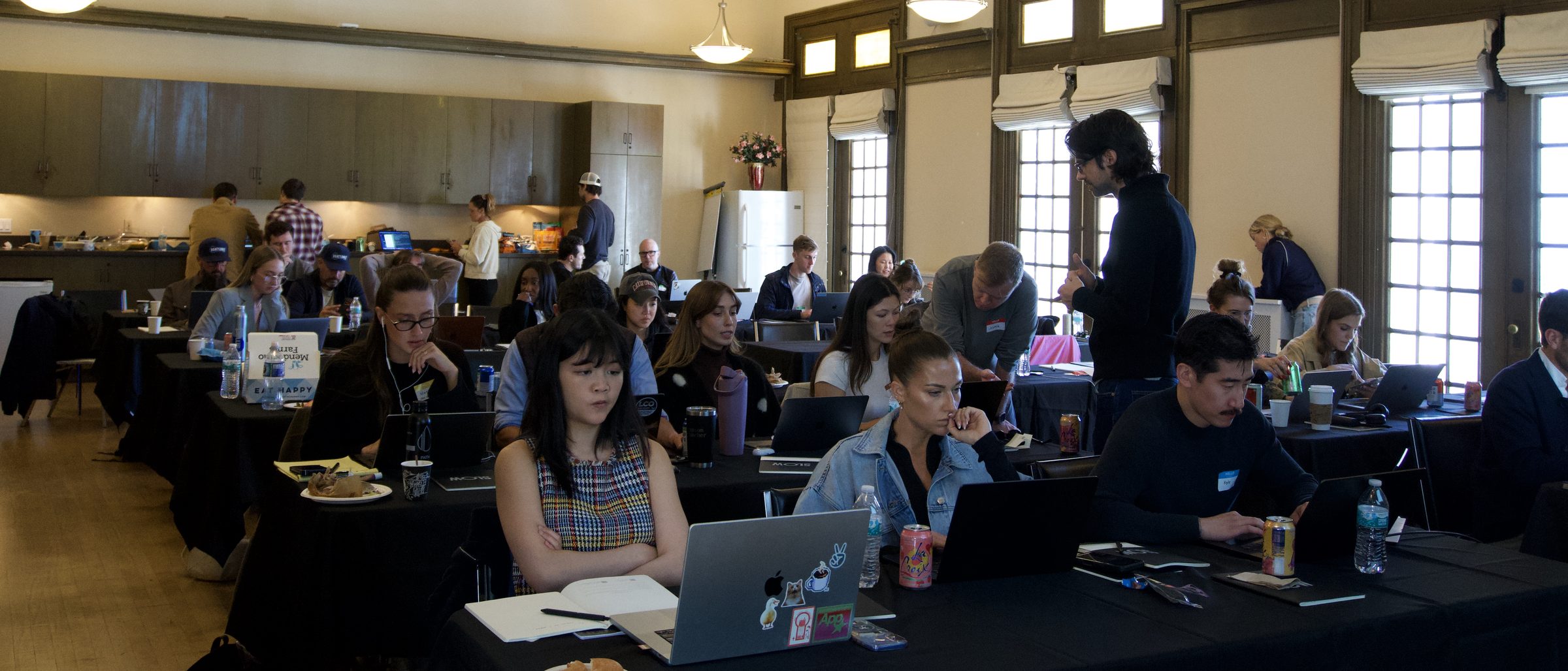 A full room of participants working on their projects
